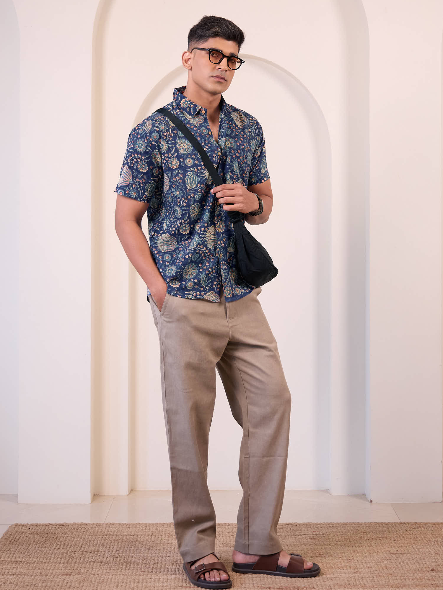 Full body view of men’s floral print shirt styled for casual vacation