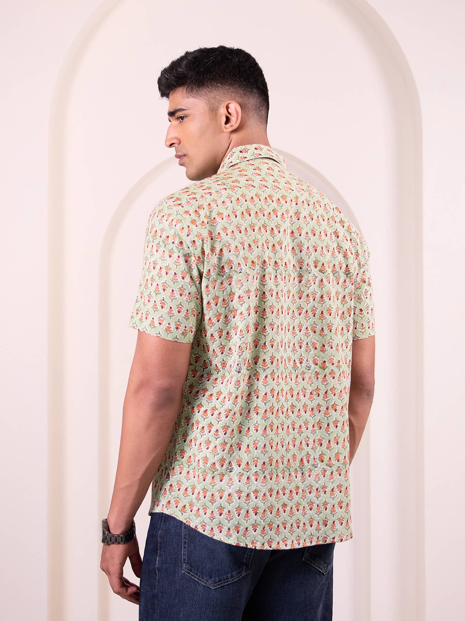 Model wearing printed short sleeve shirt back design