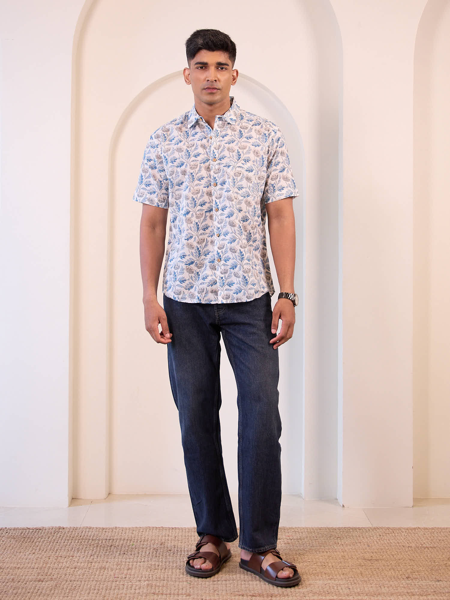 Full body view of men’s floral print shirt styled for casual vacation