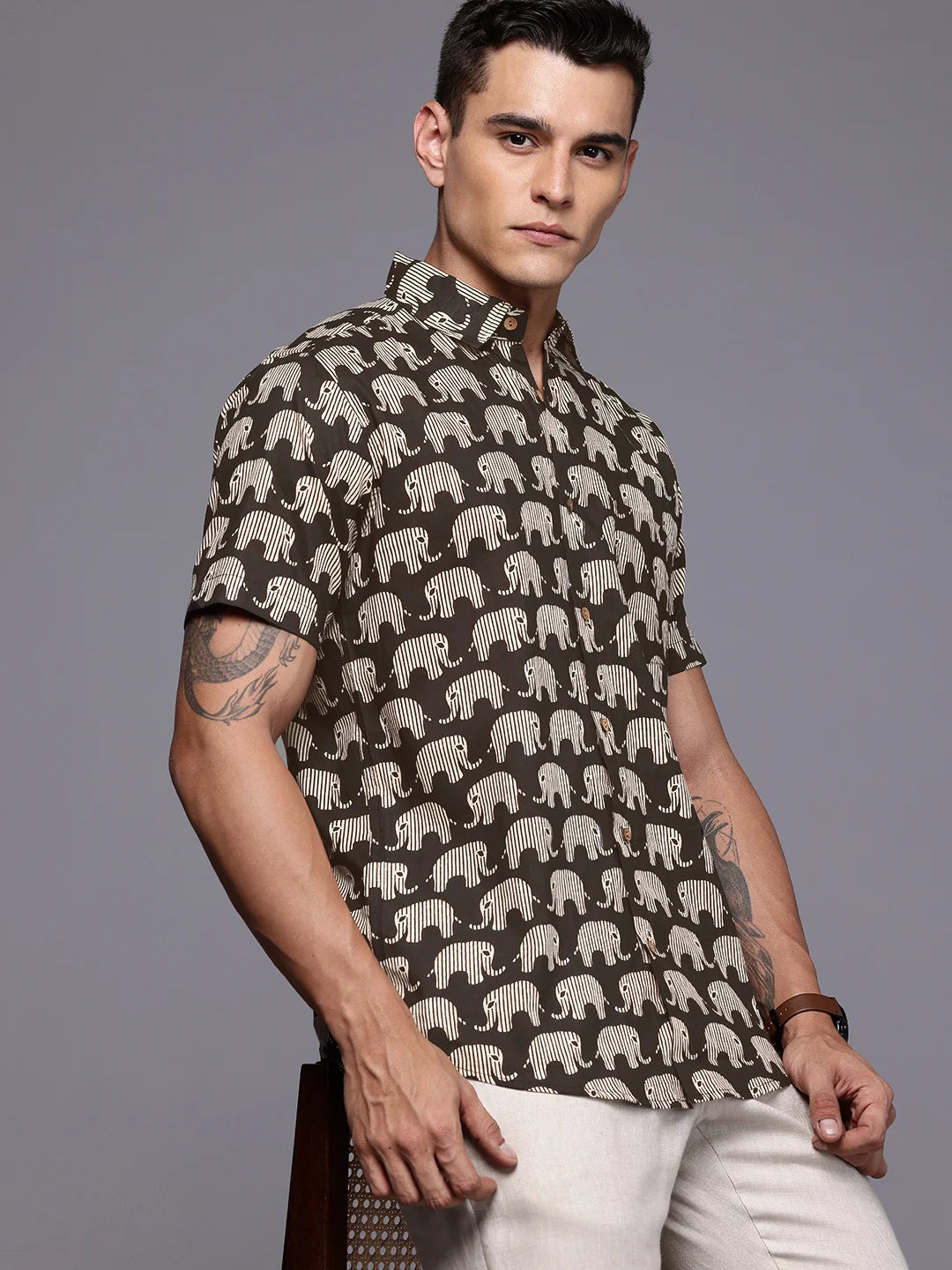 Man wearing a shirt with elephants print with short sleeves
