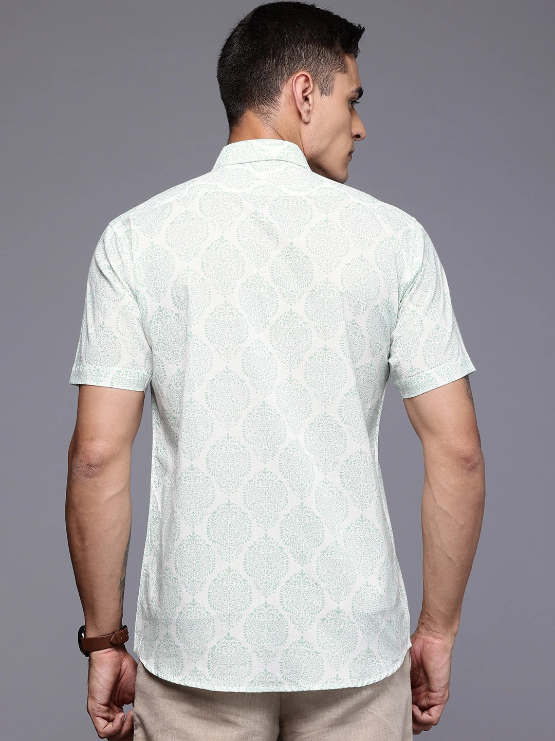 Man wearing a light-colored print shirt 